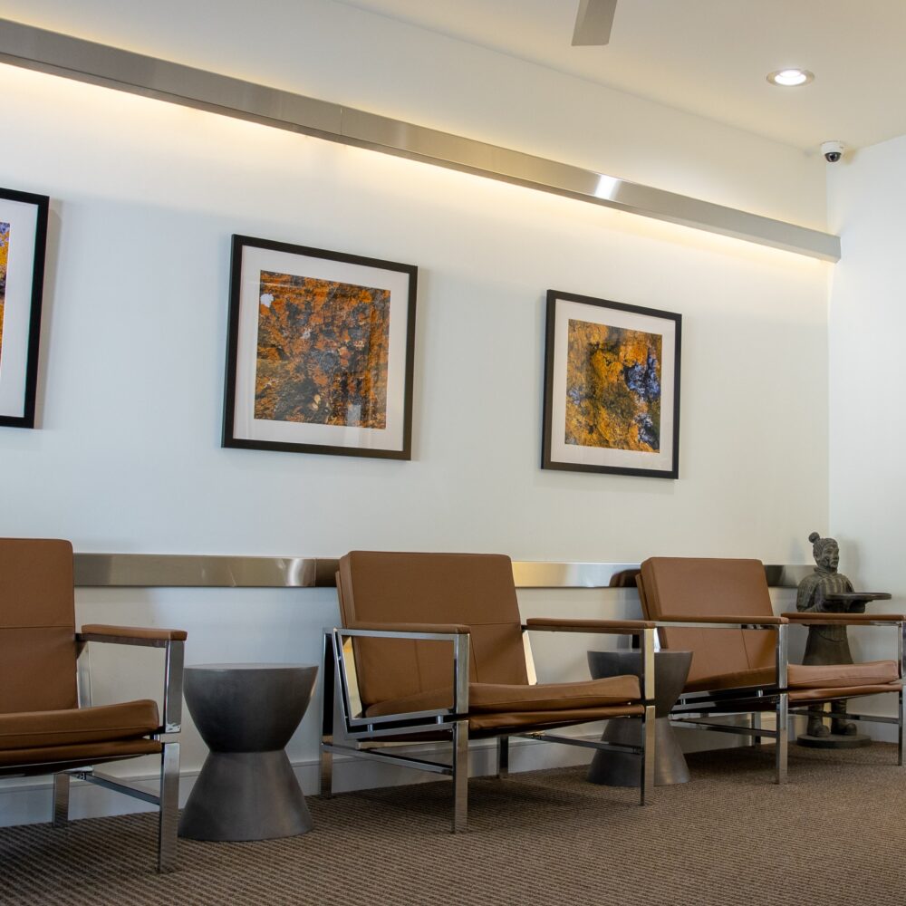 office Waiting area with chairs and painting on wall